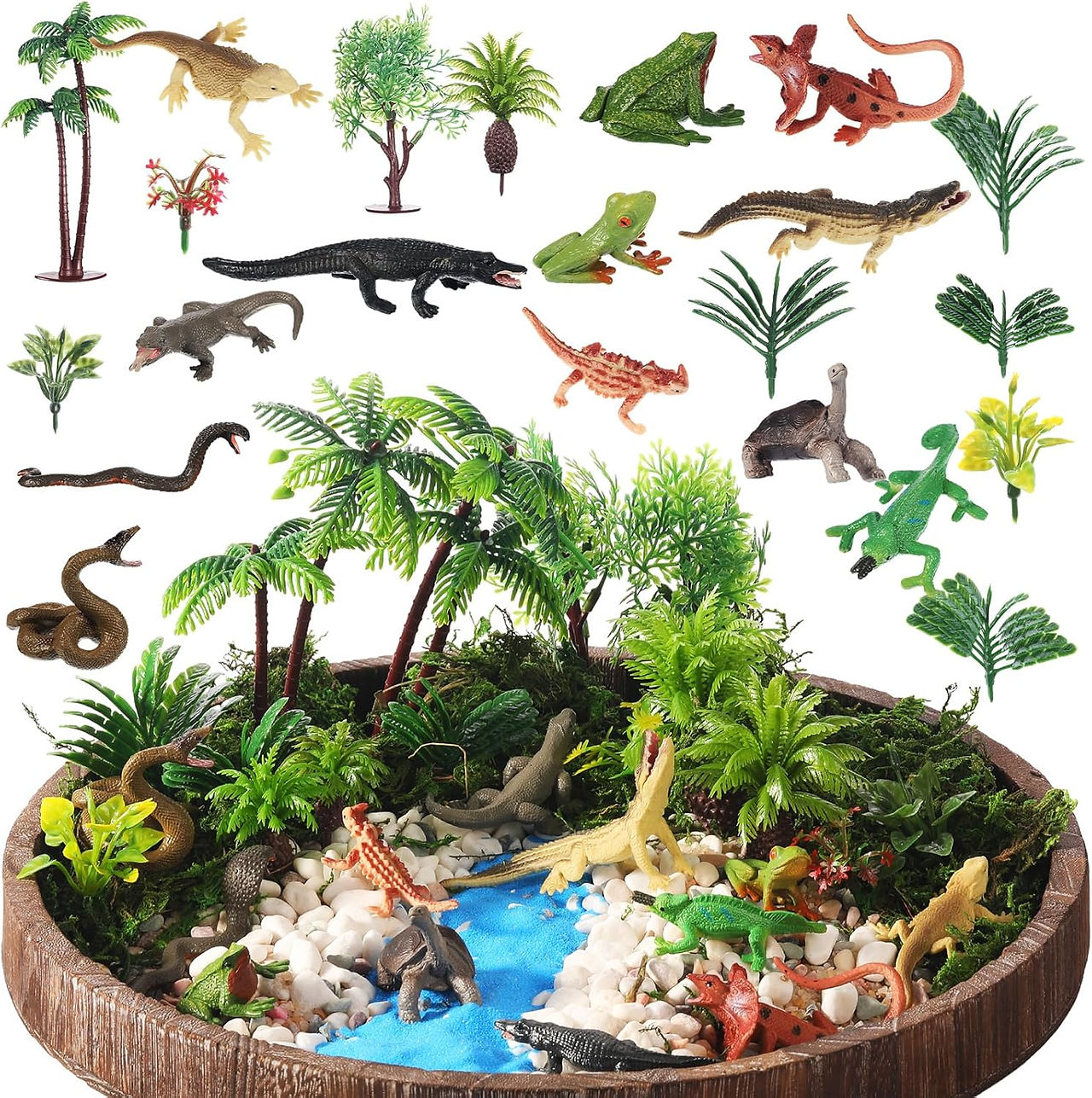 Toy reptiles, trees, and plants surround a mini blue creek with white stones. The scene is vibrant with green foliage and various animals.