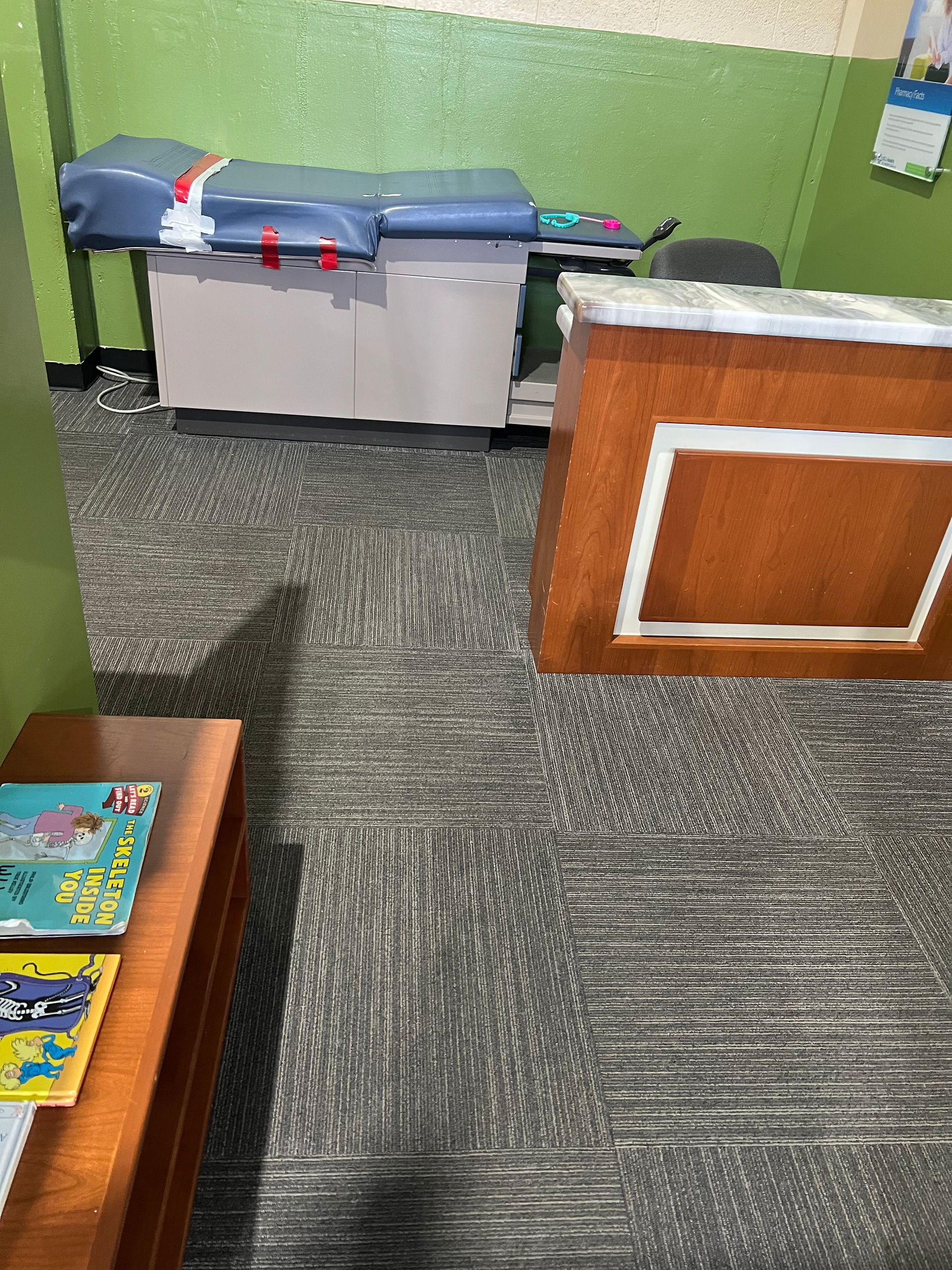 The Entrance to the Doctor's Office/Lobby with a patient exam table in the back, activities to keep patients occupied, and a receptionist's desk