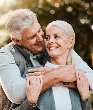 Love, hug and senior couple at a park happy, free and enjoy travel, holiday or weekend out