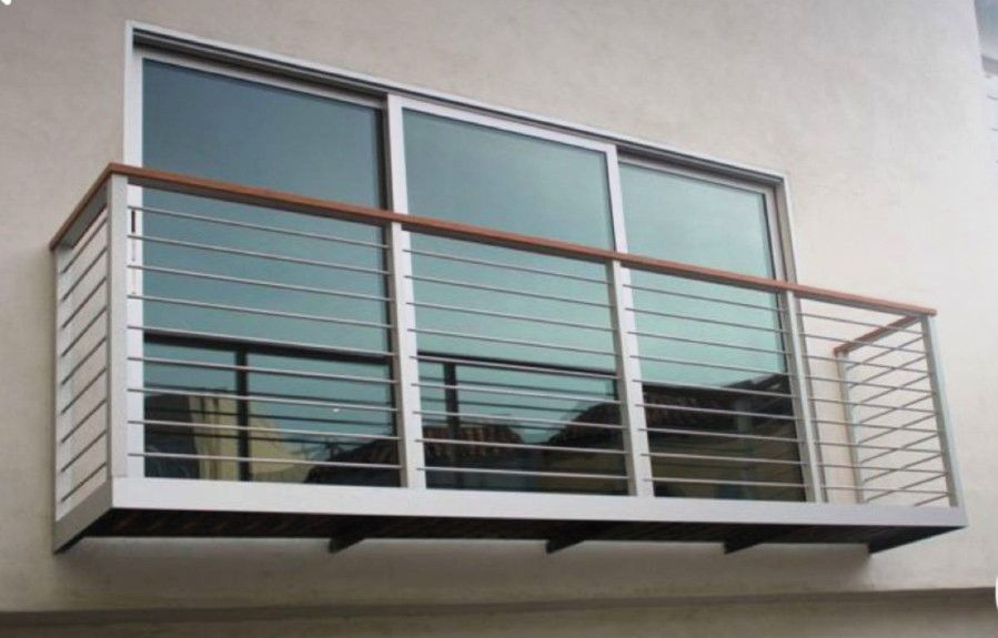 Modern metal balcony with sliding glass doors and metal railing
