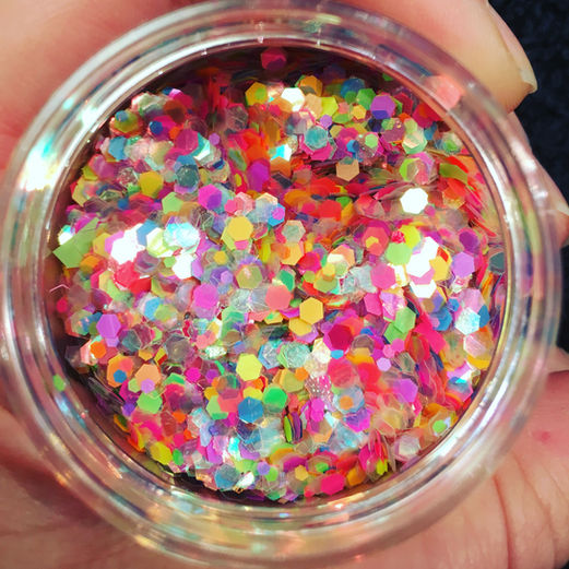 Pot of colourful cosmetic glitter