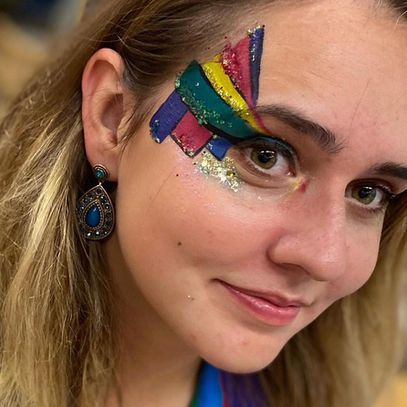 Lady wears rainbow glitter makeup and face paint for Pride parade 