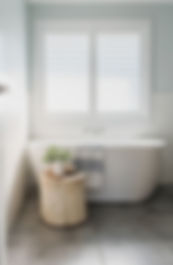 Freestanding Bath Under a White Shuttered Window