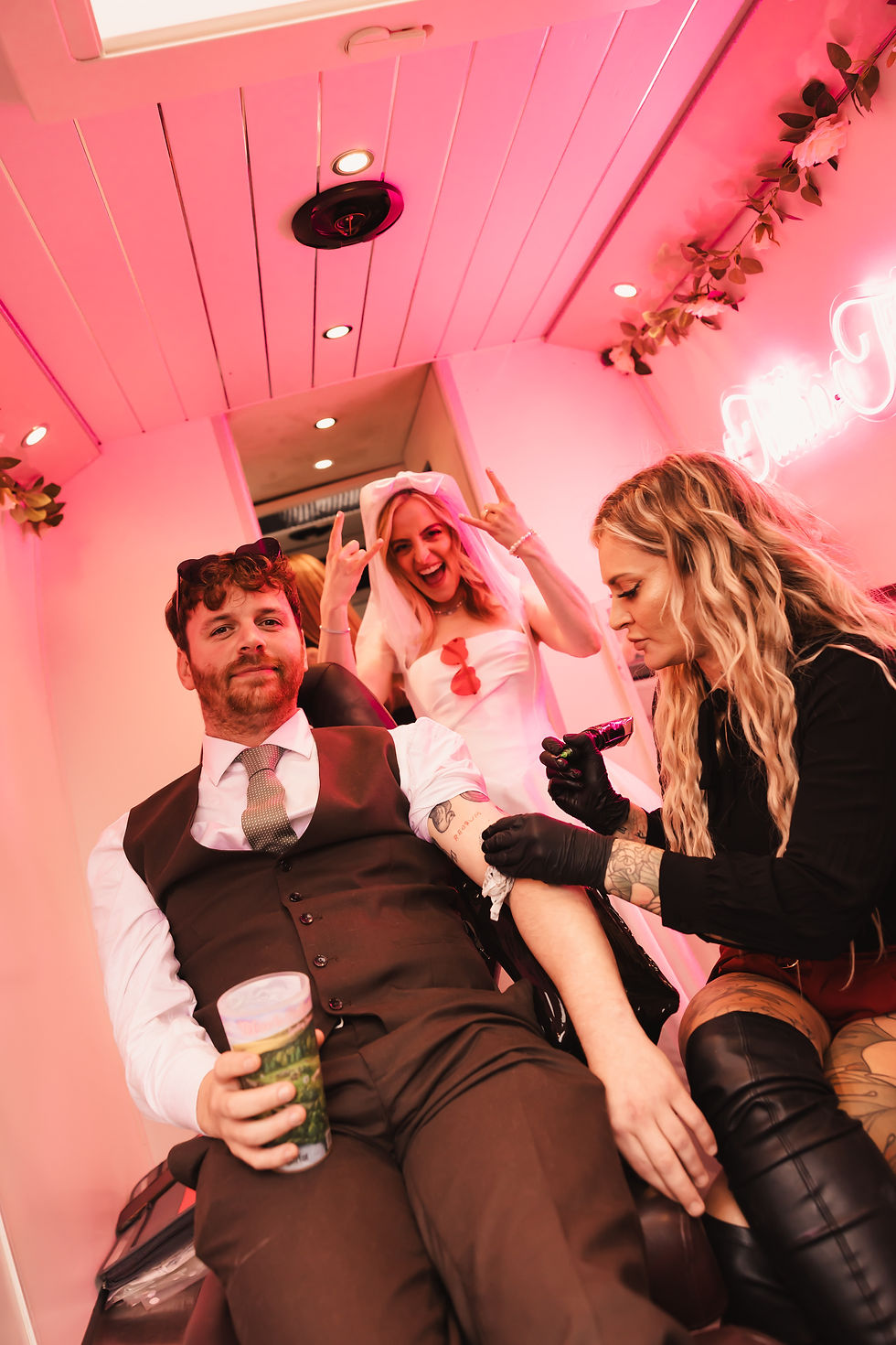 Wide-angle view of a wedding venue prepared for a creative tattoo and piercing service.