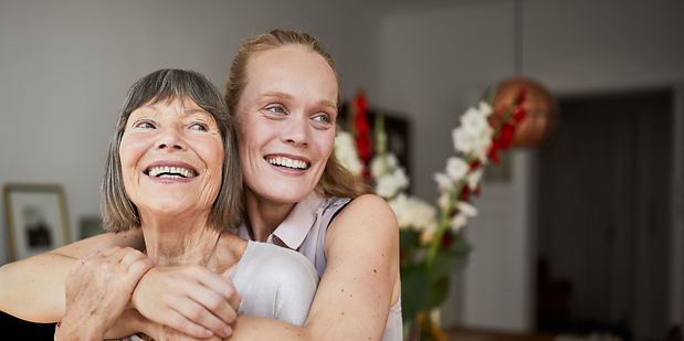 Daughter offering support to her mother with Parkinson's disease