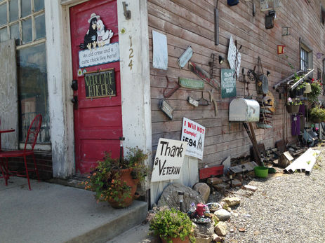 A building with signs and other objects on the side wall.