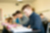 male student looking at his book smiling