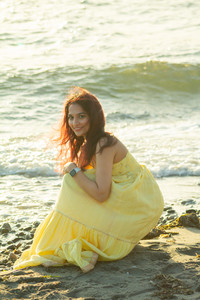 Desi woman in yellow dress posing in sand for Seattle Sunset Portrait at Golden Garden’s Beach
