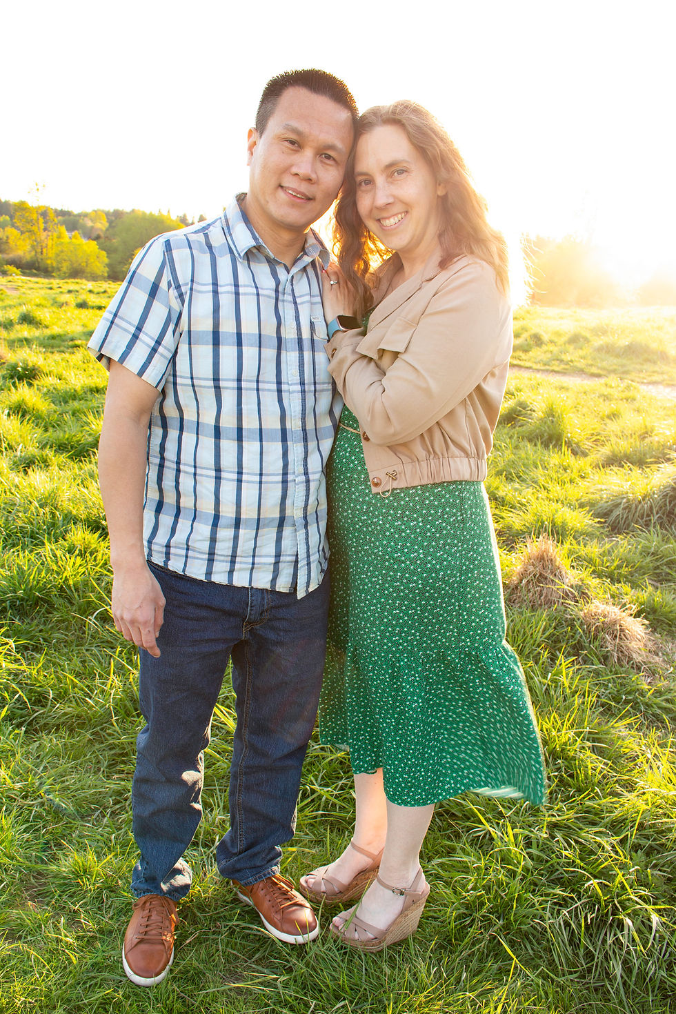 Seattle couple in Coordinating Colors for Family Portraits in grassy field