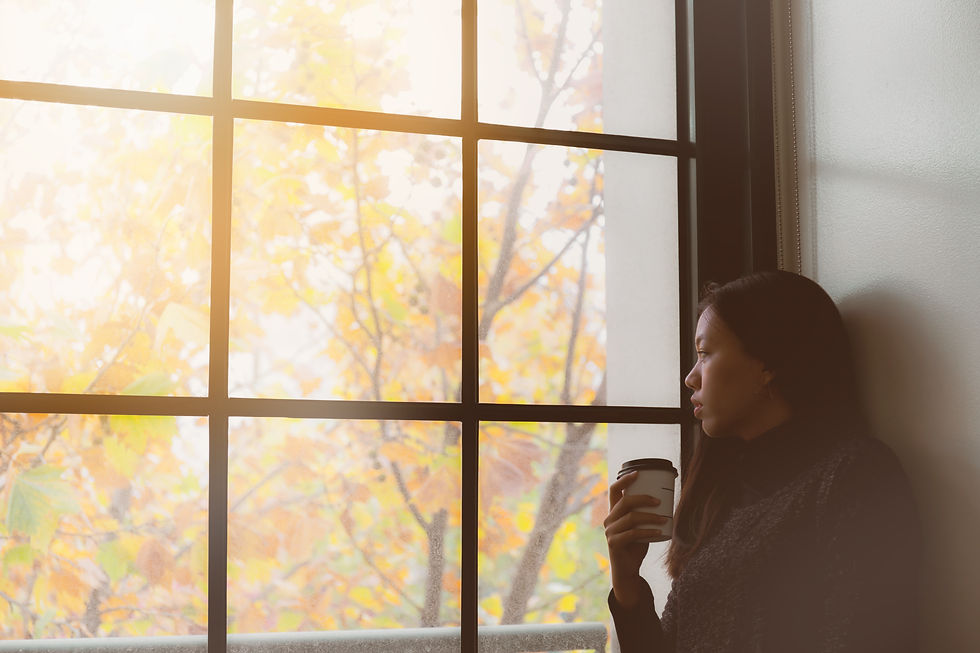 Woman looking outside a window