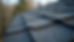 Close-up view of damaged asphalt shingles on a residential roof