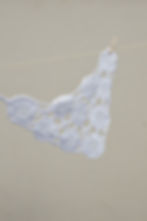 Primrose Crochet Bandana hanging on a line