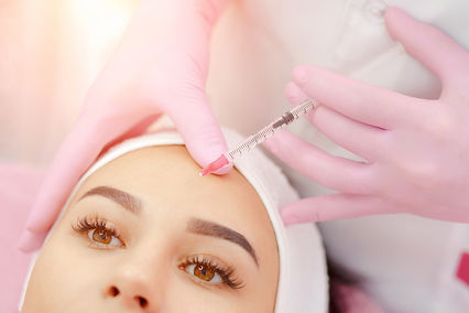 Woman gets injection in her face. Beauty woman giving botox injections. Young woman gets b