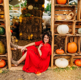 Christian woman with curly hair in a modest, feminine wardrobe, representing biblical modesty, beauty, and honoring God with the body