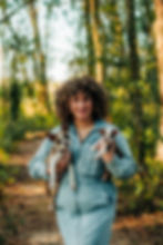 woman holding two boston terrier puppies