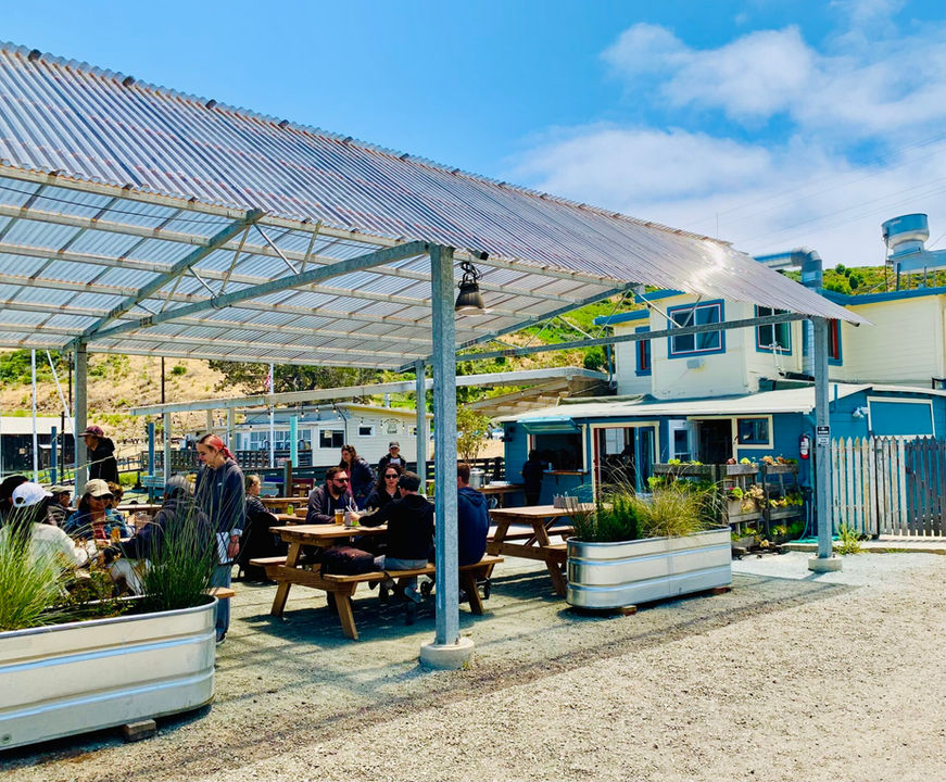 Sailing Goat outdoor dining patio, picnic tables, sunny sky