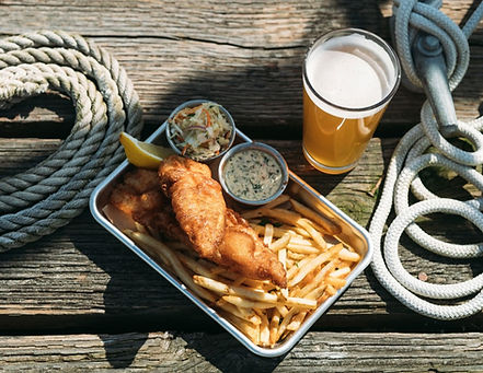 Sailing Goat fish and chips, cole slaw, french fries, glass of beer, rope