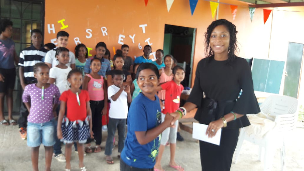 Ms Headley is presented with a appreciation gift by CPYC member