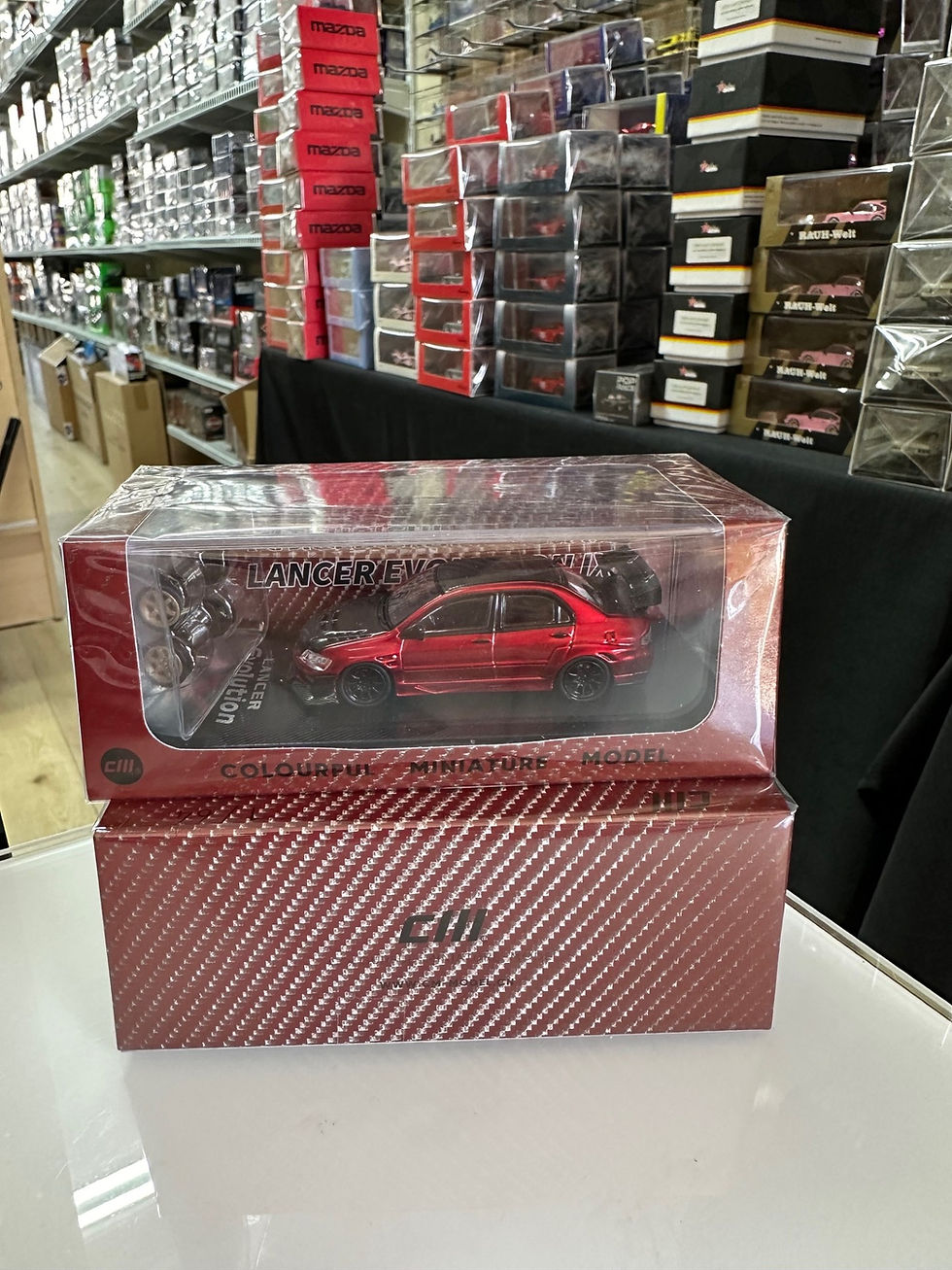 Thumbnail: MITSUBISHI LANCER EVO IX CARBON FIBER RED WITH EXTRA WHEELS 1/64 CAR CM MODELS