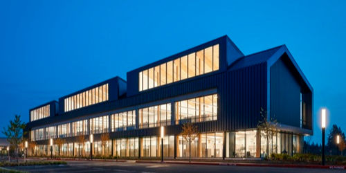 A well lit buidling facade from the outside of a credit union headquarters.