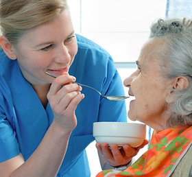 senior woman 90 years old being fed by a nurse.jpg