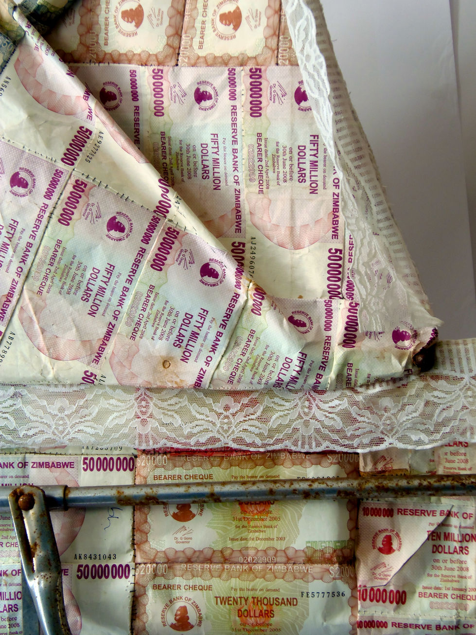 Perambulator 2011, Rusty Pram frame, Zimbabwean dollar notes stitched lace.