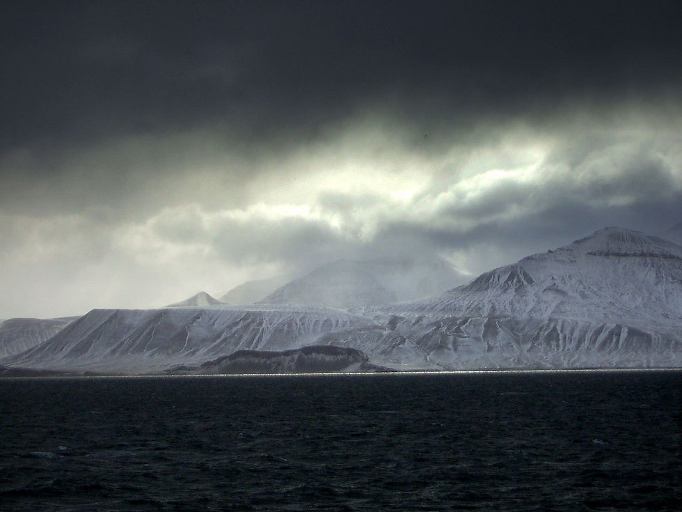 Icy cliffs against an inky black sea.