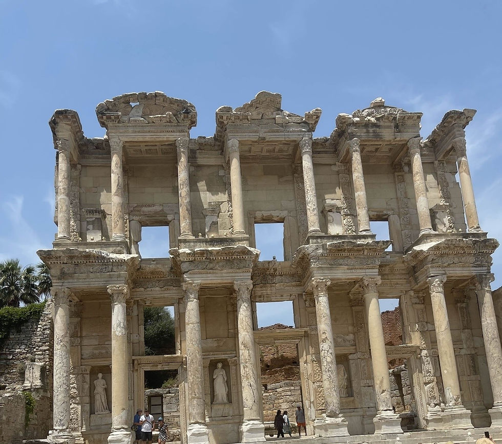 Photo shows visitors walking around the ruins of the Library of Celsus, a rectangular structure made of sand-coloured stone complete with 16 surviving, but damaged, columns and numerous windows.