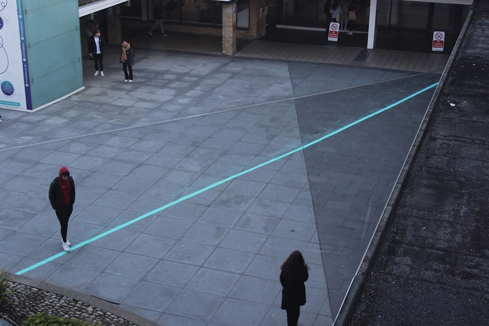 A painted line across Alexandra Square marking historical boundaries in the land.