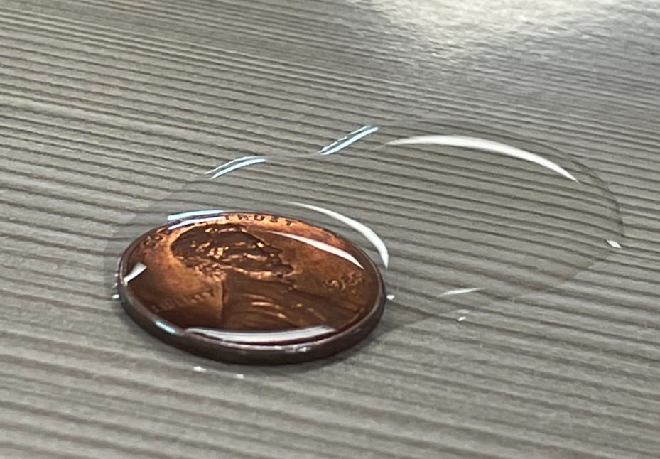 Once it spills over, it is time to dry the penny off with a paper towel, record how many drops you got, and try again.