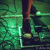 foot stepping on guitar pedals