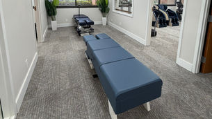 Eye-level view of chiropractic adjustment table in a clean treatment room