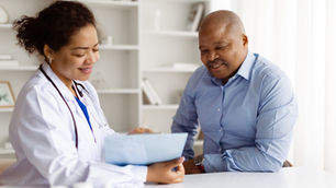 Doctor and patient in a bright office, smiling and discussing a document. Shelves in the background. Positive and professional mood.
