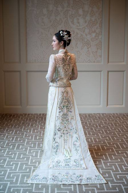sian bride in an elegant lace high neck wedding gown holding a romantic floral bouquet, photographed at a luxury Four Seasons wedding in Boston.