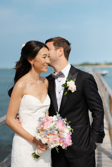Bride and groom portrait on dock at Wequassett Resort
Elaine and Alec sharing a joyful moment on a dock overlooking the water during their Cape Villa wedding at Wequassett, photographed by Jenna Kay.