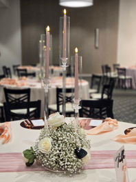 Table centerpiece with candles and flowers Pretty Petals by Tiffany event rentals
