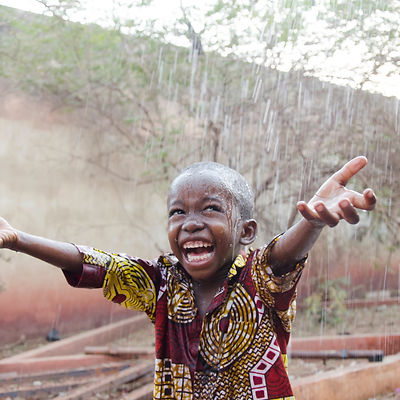 Sweet little African boy under the rain in Mali (Africa).jpg