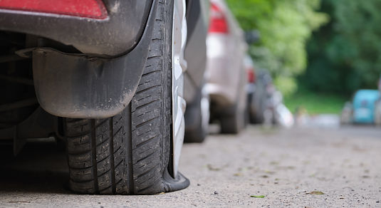 car-with-punctured-flat-tire-parked-on-roadside-2022-03-29-23-51-25-utc.jpg