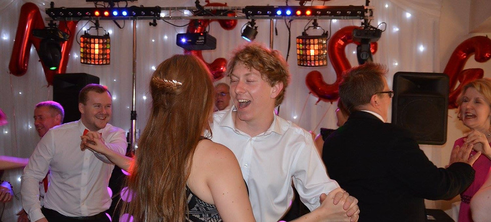 DJ Andy Richardson playing for guests dancing at birthday party