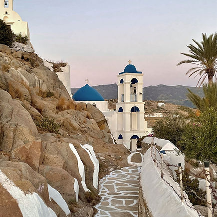 Traditional white church with blue dome in Mykonos Old Town