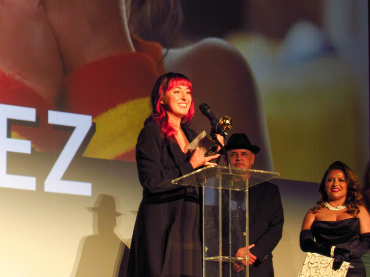 rom left, Kaila Gutierrez, accepts the “Best Director” award for “Nana Carmen,” presented by Enrique