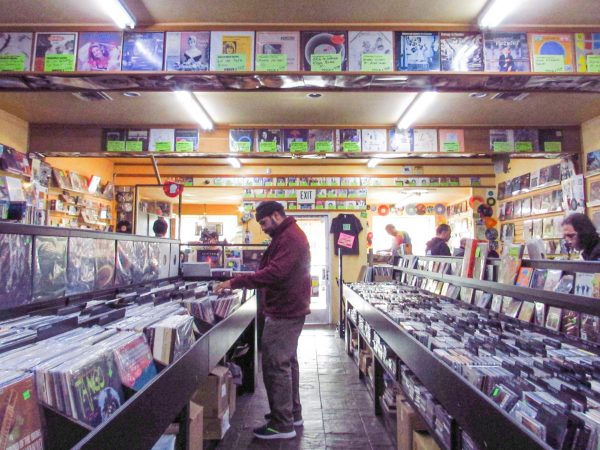 In the middle of Freakbeat Records’ vinyl/CD aisle, with shoppers browsing their selection. (Nyan Gavino)