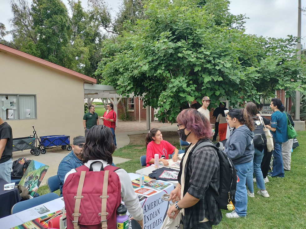 Attendees of the “Native American Welcome” event receive information from the CSUN American Indian Studies booth on Sept. 20, 2023, in Northridge, Calif. (Jesse Illanes)