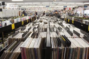 In-between the record aisles at CD Trader in Tarzana, as shoppers browse the record selection. (Madeleine Christian)