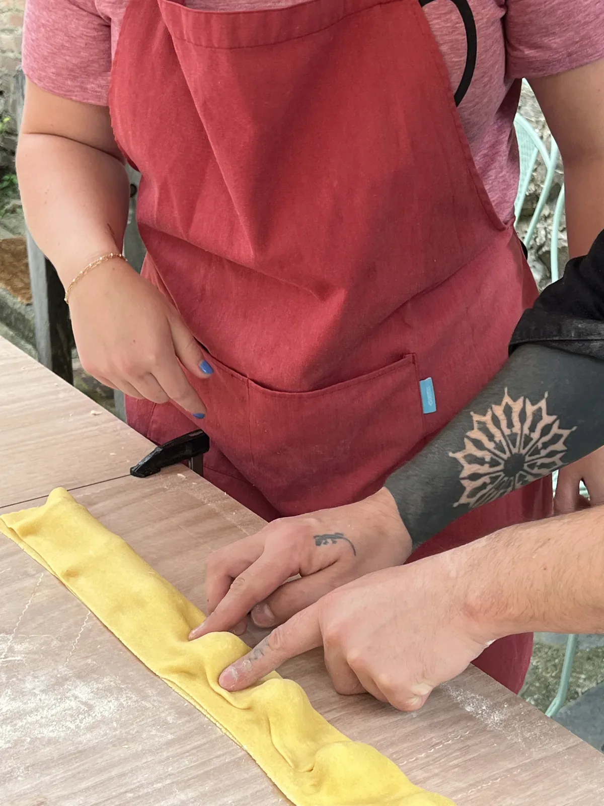 Hands shaping pasta on the work surface