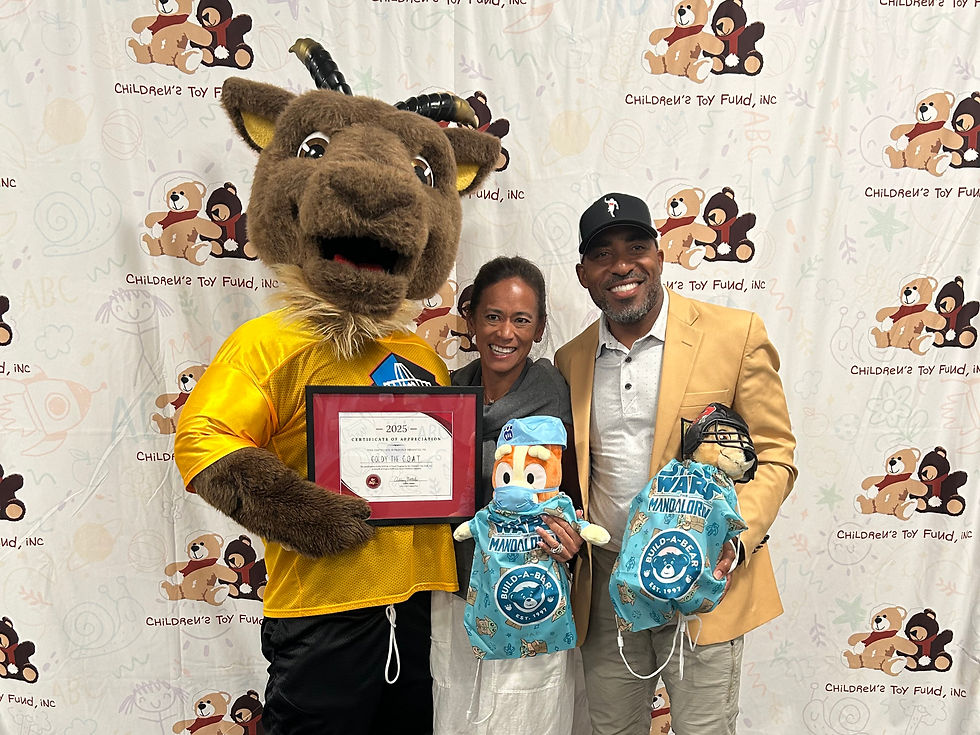 Pro Football Hall of Fame's Goldy the G.O.A.T. and hall of famer Ronde Barber with his wife take the time to interact with Be A Friend Program event attendees and make stuffed animals to donate to a child at Akron Children's Hospital in Tom Benson Hall of Fame locker rooms, Canton, Ohio, June 2025.