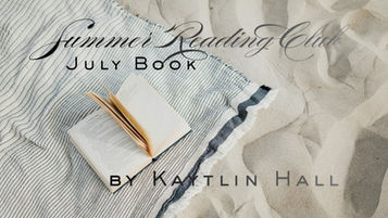Blanket and open book on beach