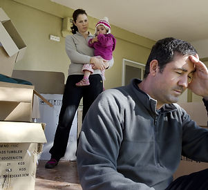 Upset young parents and their daughter outside their home.Divorce, homelessness, eviction,