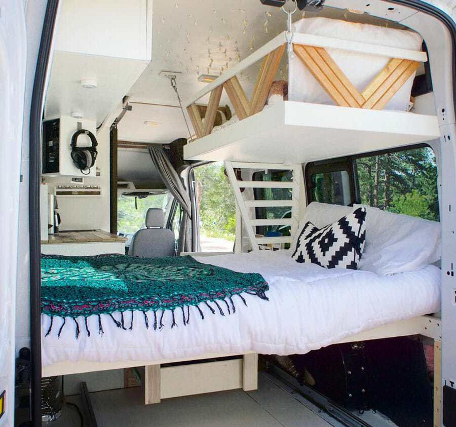 a van conversion with a single bunk hanging from heavy duty rings from the ceiling