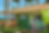 Two kids at a beachside shack counter receiving drinks from a smiling server. Green building, palm trees, ocean view. Text: Shakes, Sweets, and More.